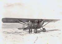 Bud Kipp standing by Al Kruger's Monocoupe