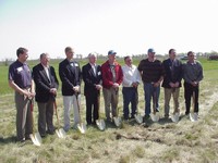Representatives from the organizations involved gather to break the first ground for the Wind Farm on May 22, 2003